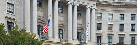 Pillared building with American flag flying from it