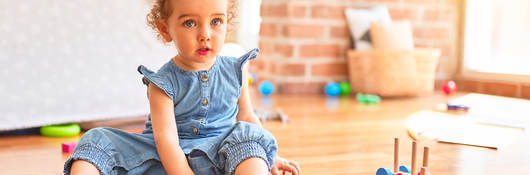 Child playing with wooden toys