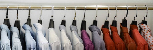 Close-Up Of Colorful Clothes Hanging On Rack At Store