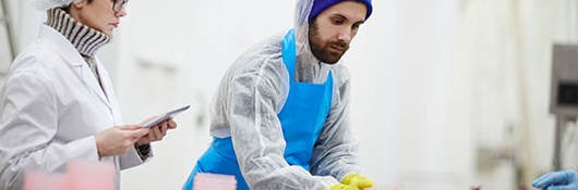Man with blue beanie looks over food contact materials 