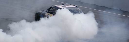 Race car drifting with smoke behind it