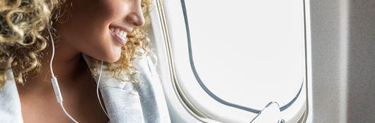 Woman with cell phone on flight