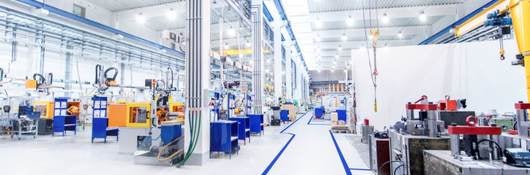 warehouse with clean white floor, machinery and bright commercial lighting