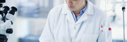 Female laboratory employee at work, taking notes in a lab setting