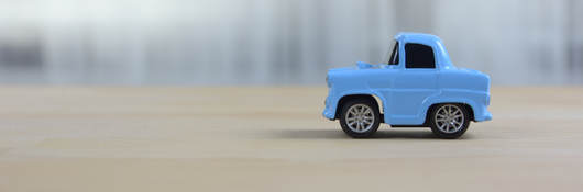Blue old style toy car on a table