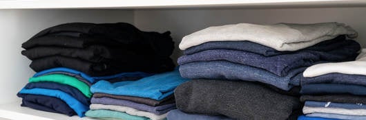 Shelf with folded clothing