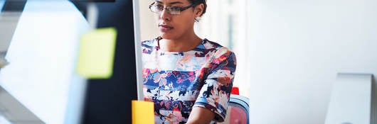 Woman reading news on computer screen