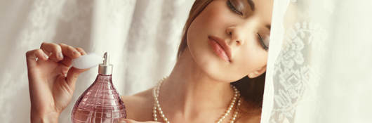 Woman applying perfume
