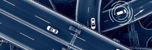 Close -up of a car driving in a city at dusk
