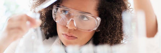 Female scientist looking at a flask