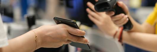 a mobile phone scanned for payment in shop