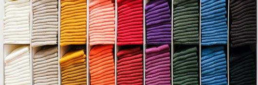 Colorful clothes on a retail shelf