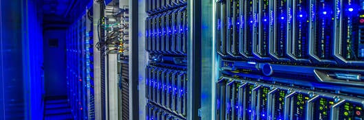 Interior of data center with equipment trimmed in blue LED lighting