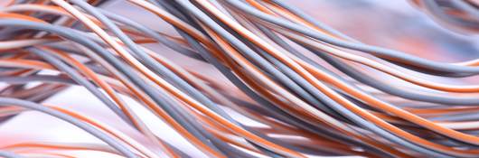 A closeup look at a swirl of electric cables and wires.