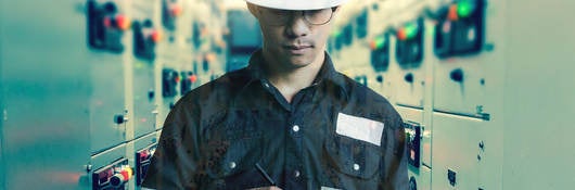 Double exposure of Engineer or Technician man working with tablet in switch gear electrical room of oil and gas platform or plant industrial for monitor process, business and industry concept.