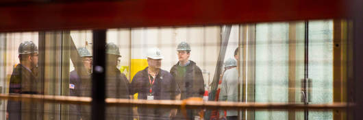 Employees discussing while standing in testing facility