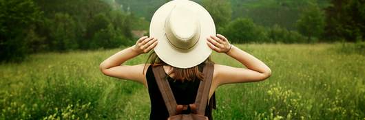 Woman traveler with backpack in nature