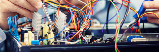 Electronics engineer repairs an audio/video device