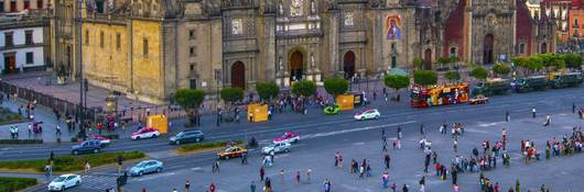 Image of a government building and foot traffic on a busy street in Mexico City, Mexico.
