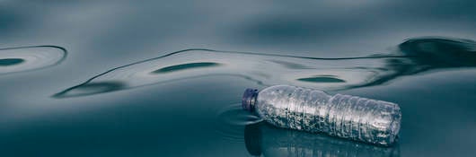 Plastic bottle floating on water