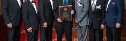 Kerry Bell of UL Solutions accepts award alongside NFPA members. 