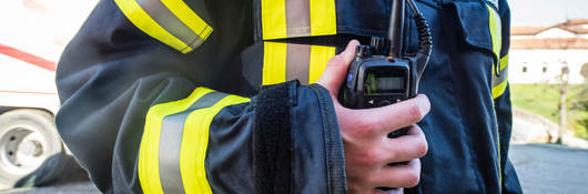 Firefighter using a walkie-talkie during a rescue operation