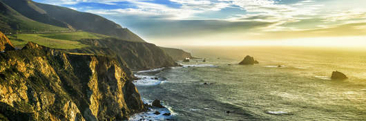 The coastline at Big Sur, California, with steep cliffs and rock stacks in the Pacific Ocean