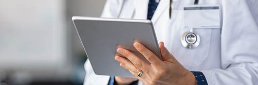 Doctor reading patient reports on a tablet