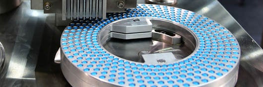 Blue capsule pack at medicine pill production line