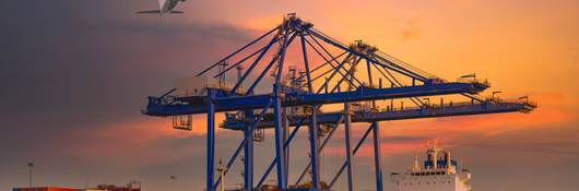 Airplanes flying over container terminals.
