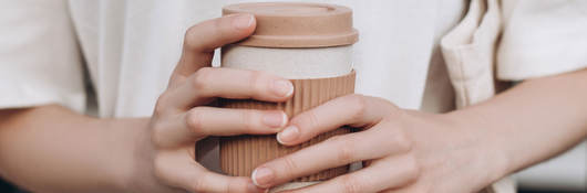 A person holding a coffee mug