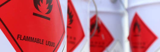 White drums with red flammable liquid symbol on the side