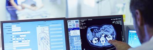 Doctor running CT scan from control room.