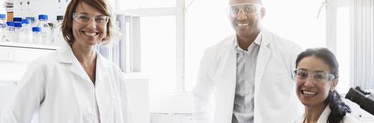 Smiling chemists at laboratory.