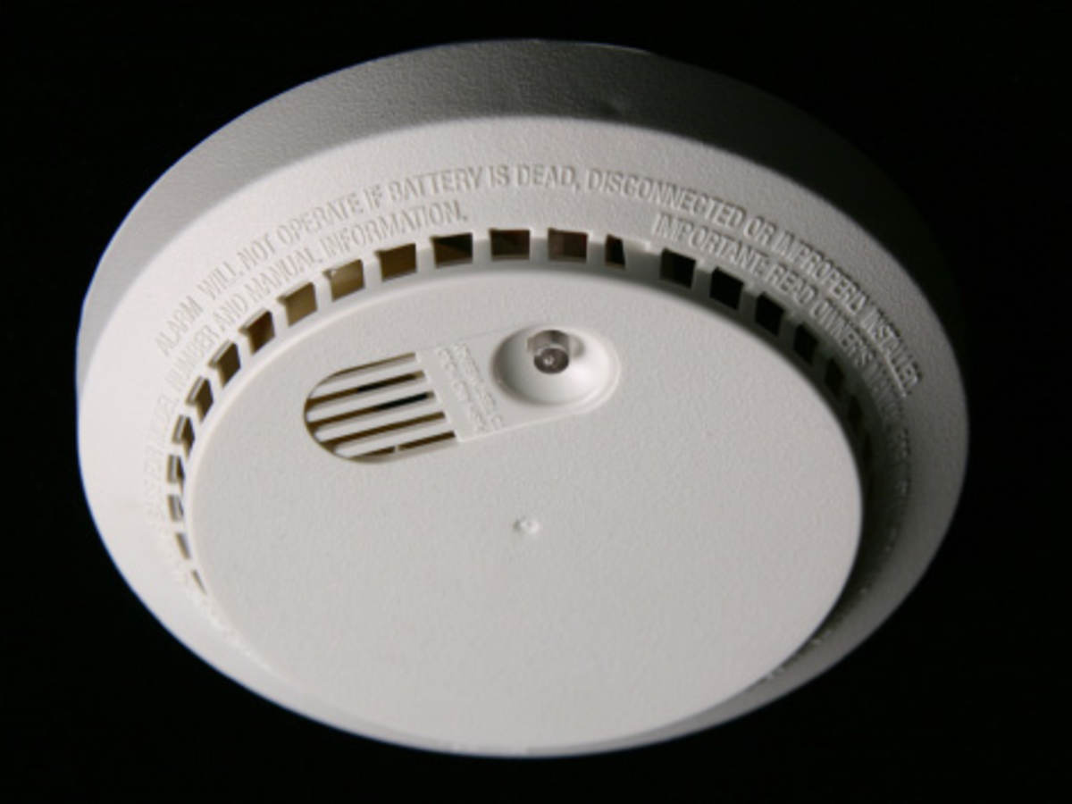 Man testing smoke alarm