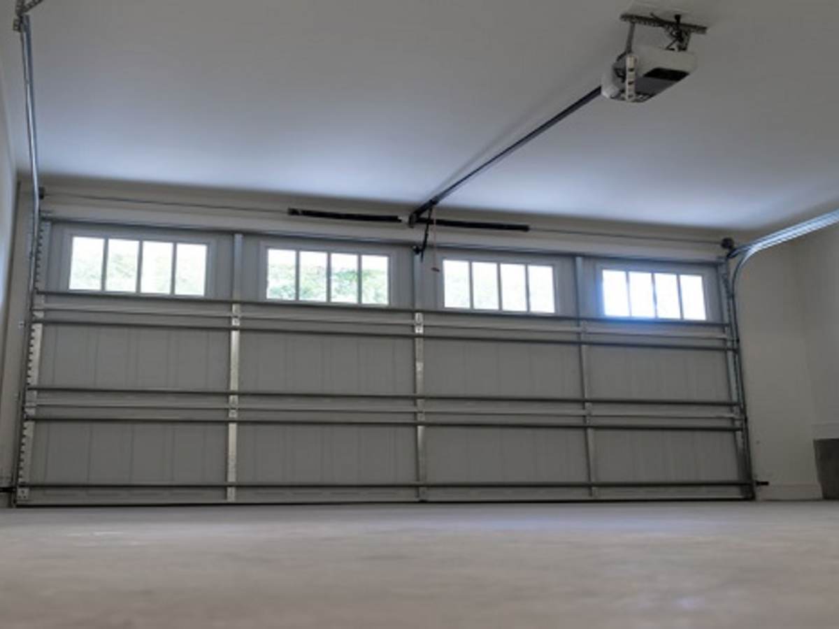 a closed, garage door with automatic opener centered to image.