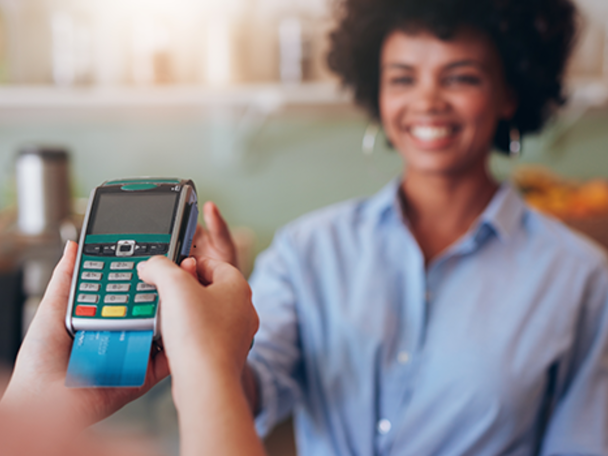 Woman paying for a retail transaction with EMV technology.