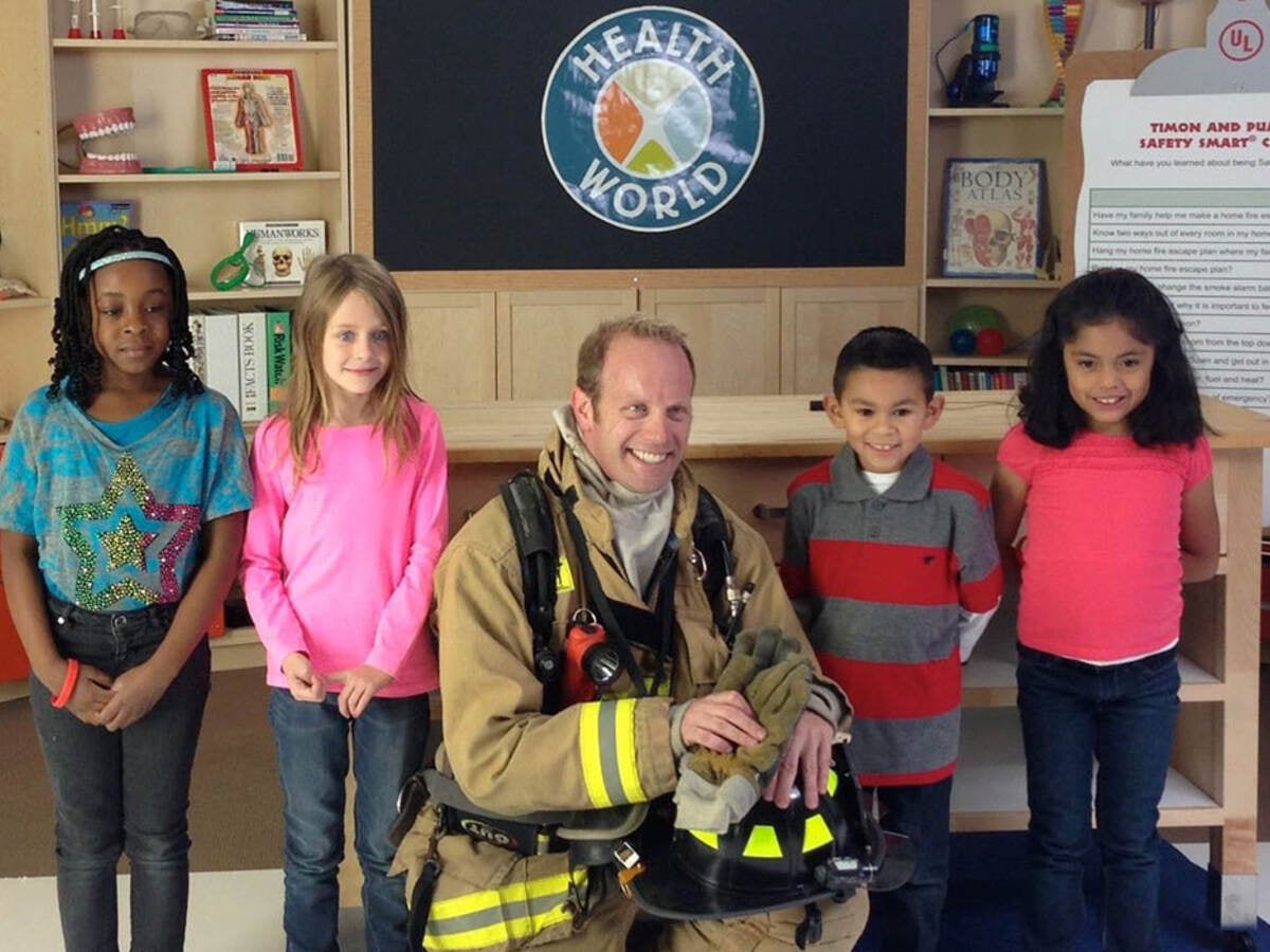 fireman and children in front of safety smart logo