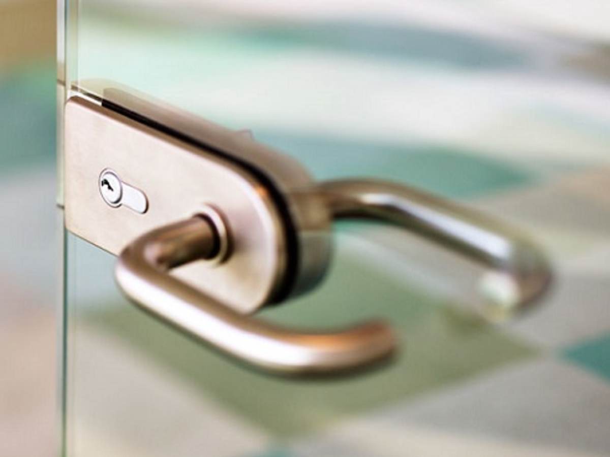 an abstract detail of a contemporary door handle for a glass door
