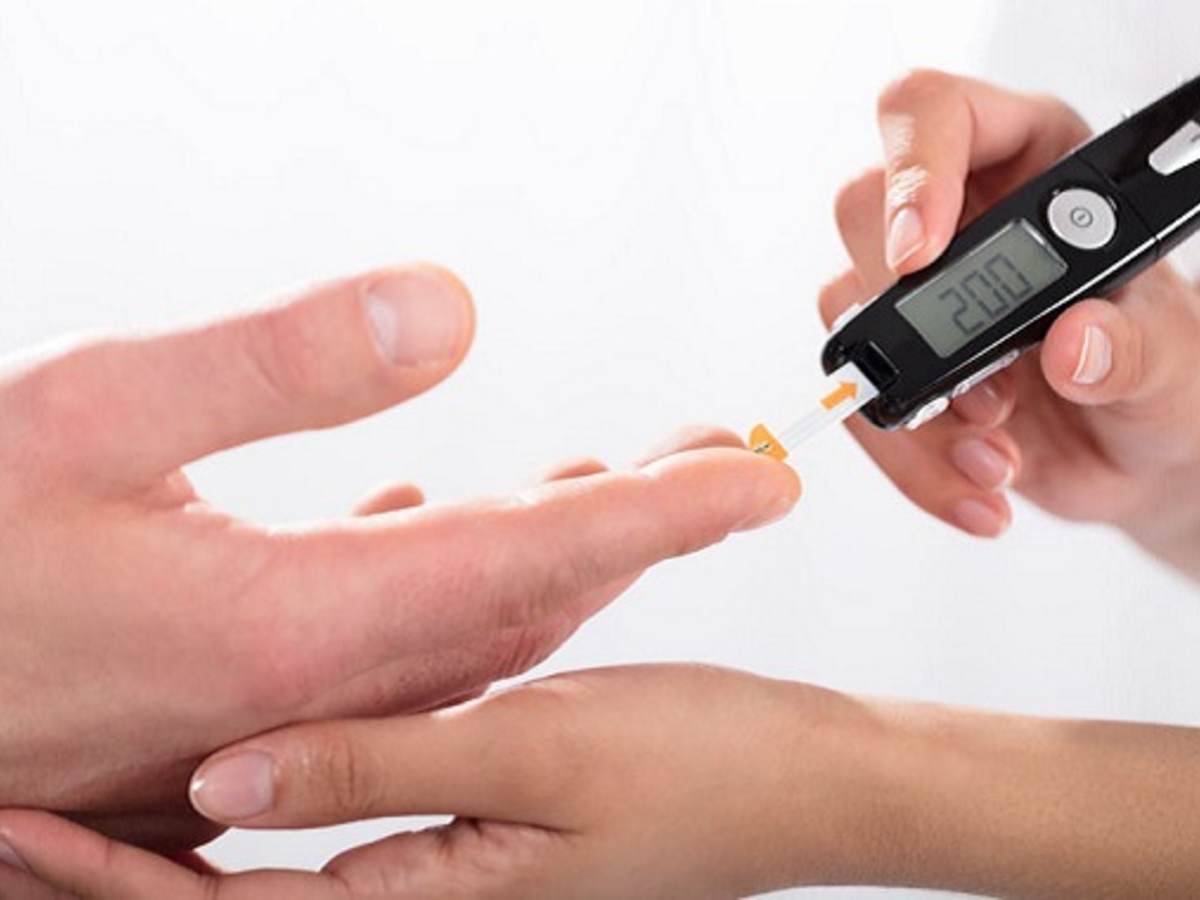 doctors hand holding glucose measure scanning pen on patients finger