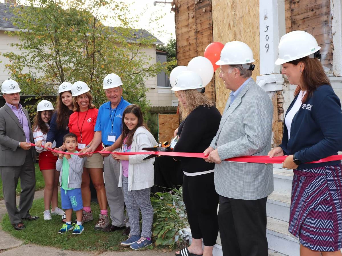 UL sponsors stand with Habitat for Humanity officials at a ribbon cutting ceremony