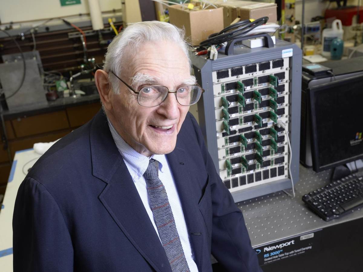 John Goodenough sitting in his lab in front of lab equipment