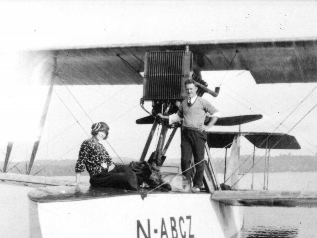 Two passengers enjoy a seaplane that bears a UL Registration Mfark, ca. 1922. | 