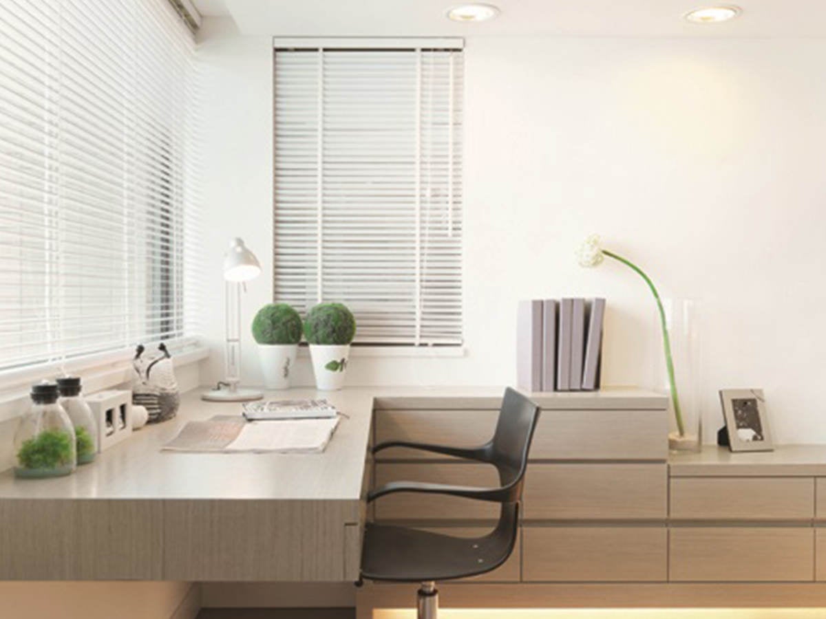 Modern office space with windows, desk and chair