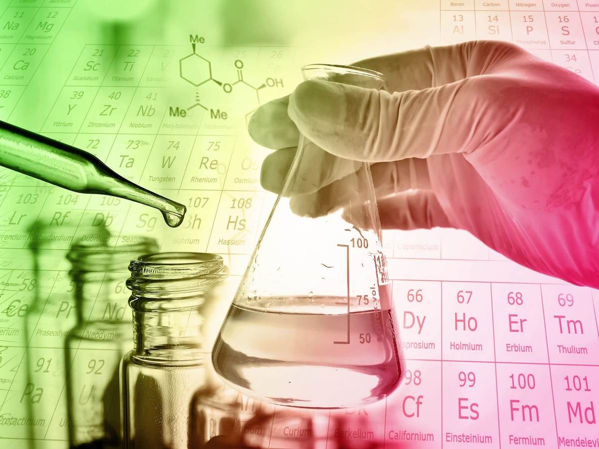Flask in scientist hand with test tube in rack