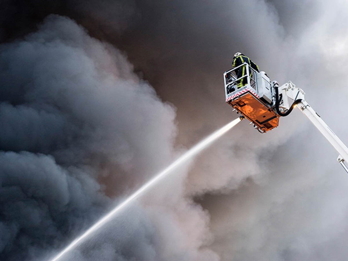 Firefighter spraying water on a fire