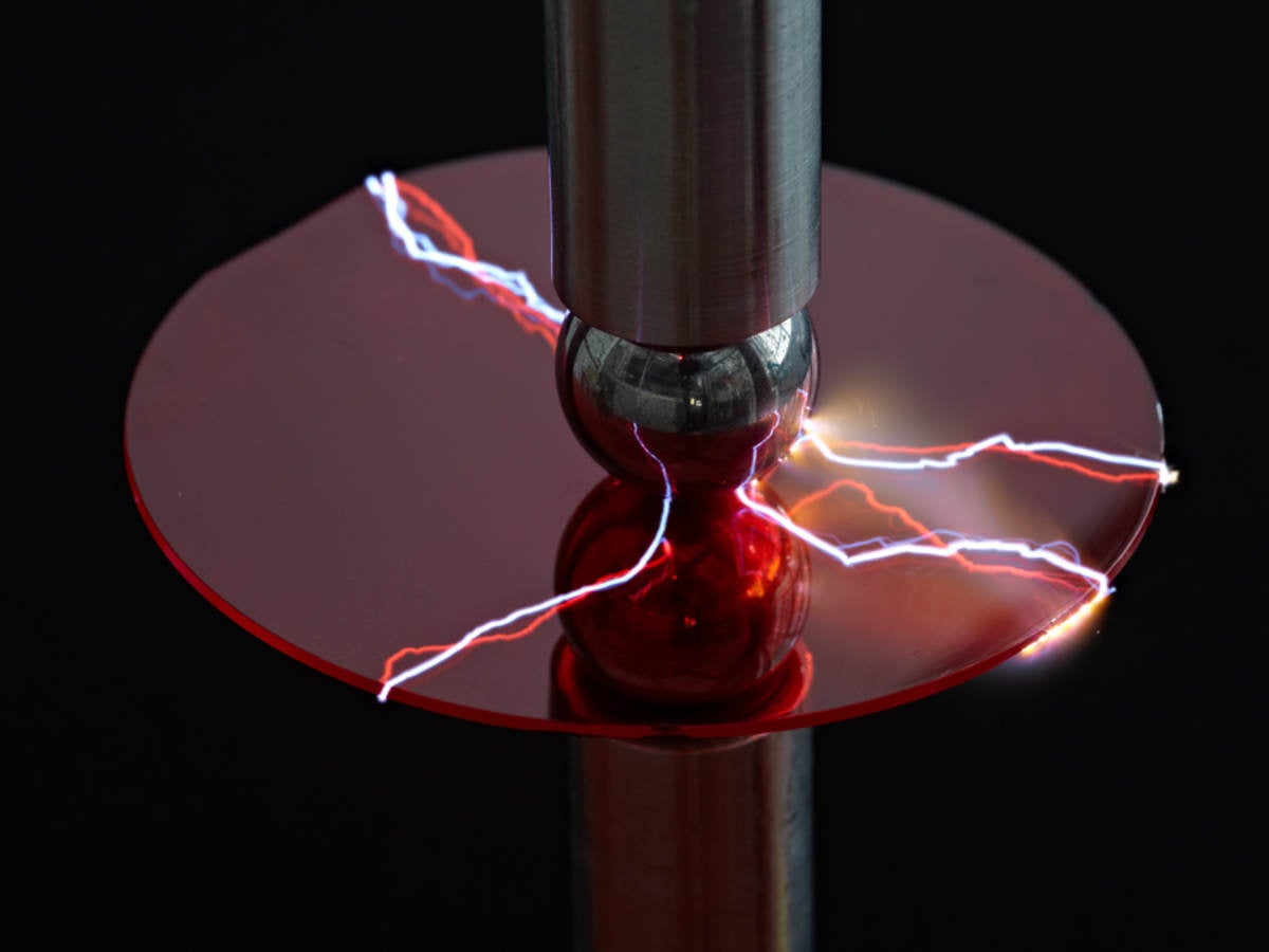 A machine using electricity to test a piece of plastic. 