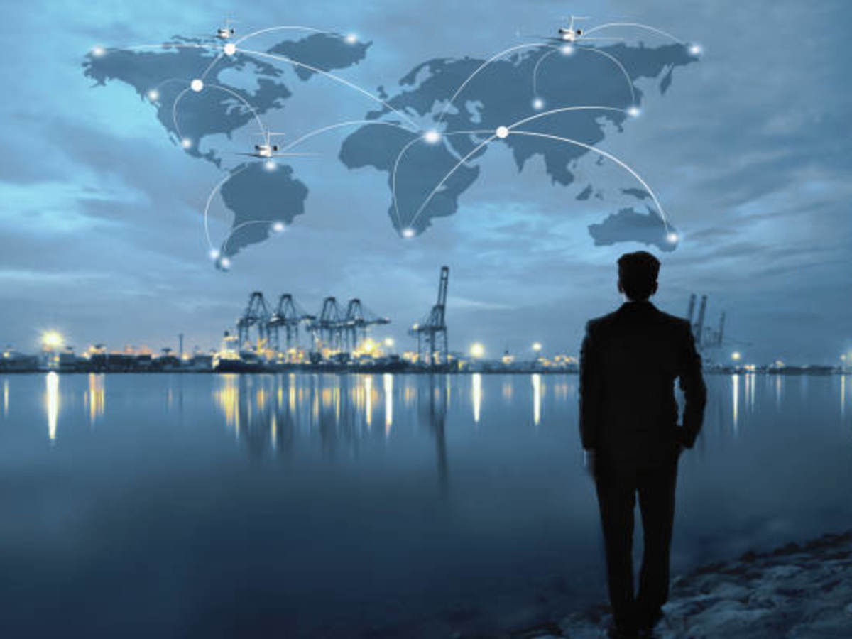 Man at a lake with night skyline and superimposed world map