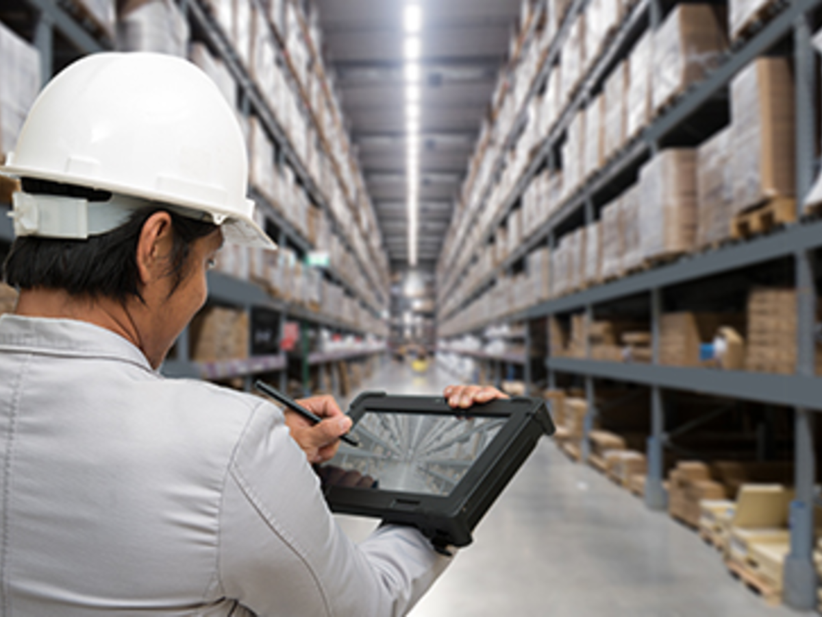 Man in hardhat w/ipad in warehouse w/H-frame