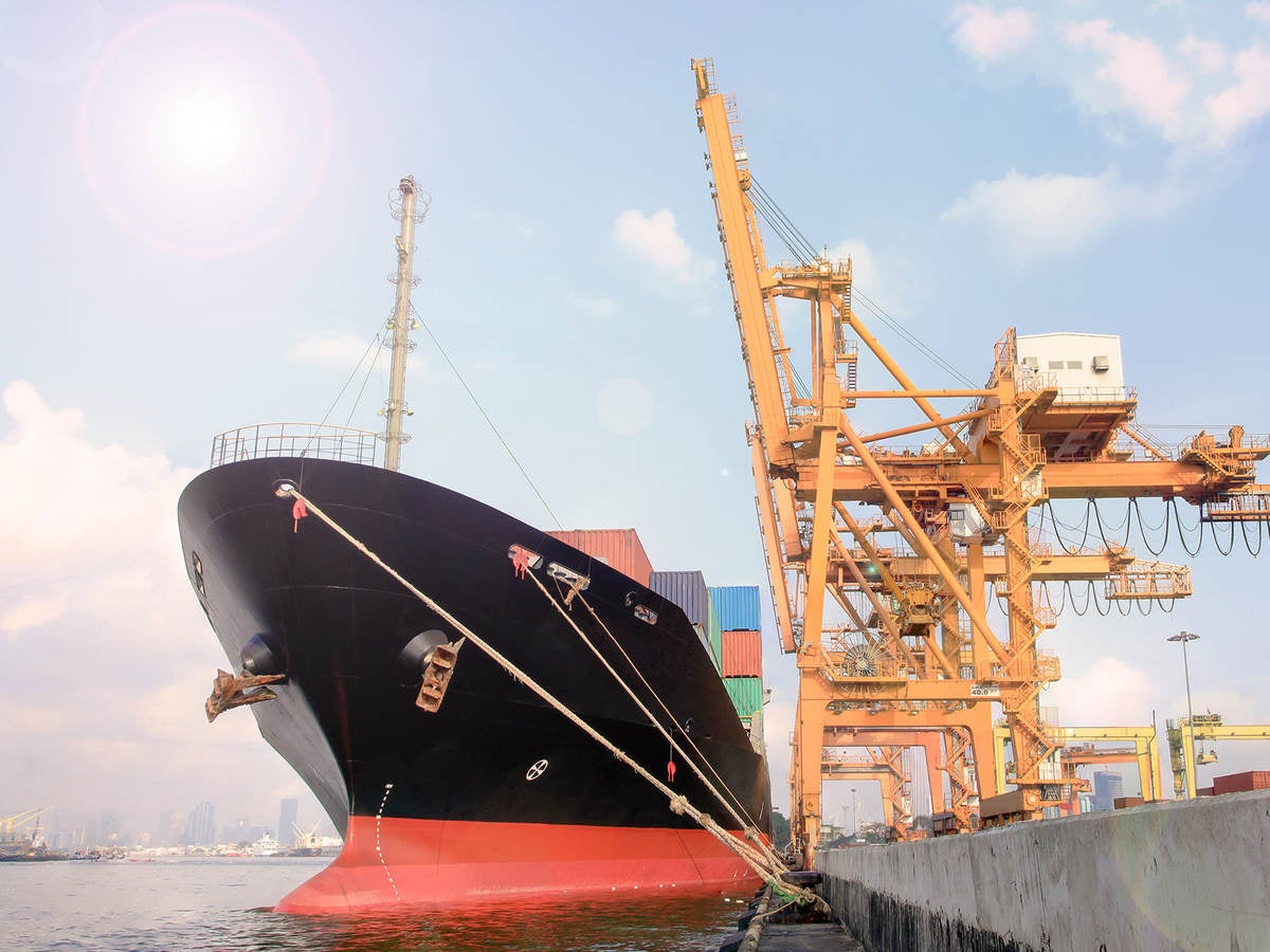 Container ship being loaded in harbor